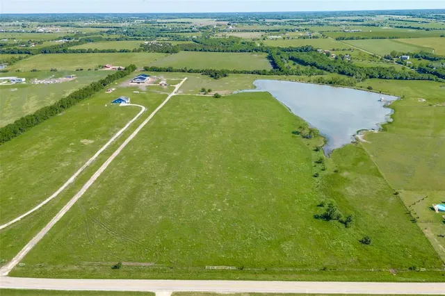 a view of a lake with a large yard