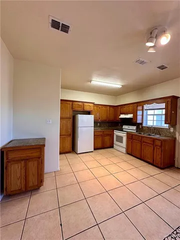 a large kitchen with stainless steel appliances a cabinets and counter space