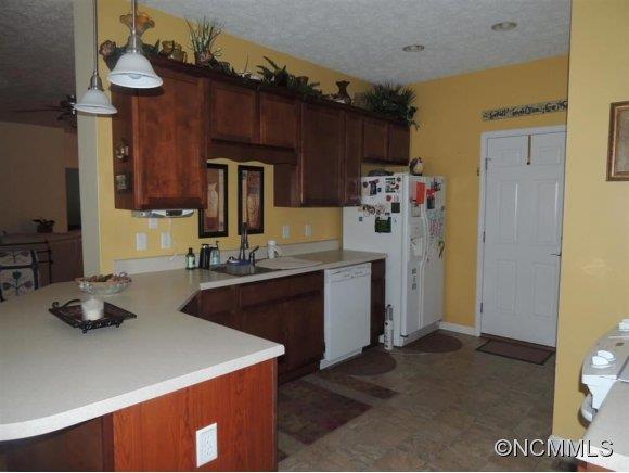 685 Lattimore Road Rutherfordton, NC 28139 - Photo 5 of 11 a kitchen with a sink refrigerator and microwave