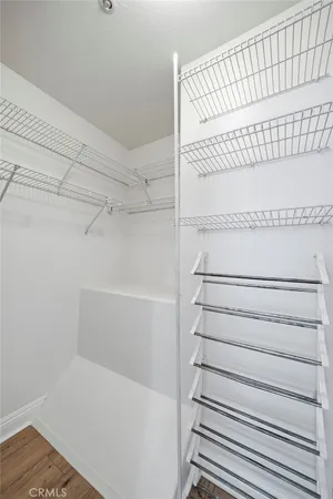 a view of staircase with white walls and a white door