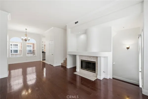 an empty room with wooden floor and fireplace
