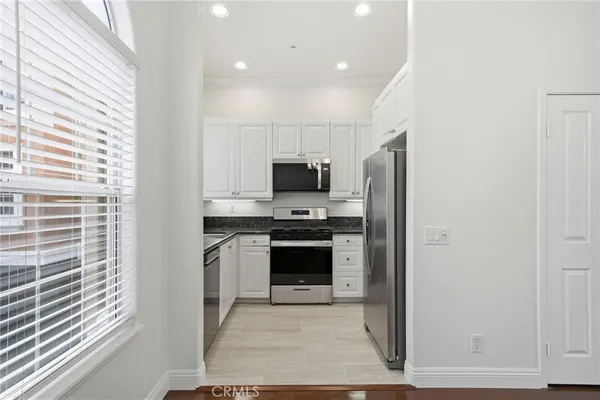 a kitchen with stainless steel appliances a stove a microwave and a refrigerator