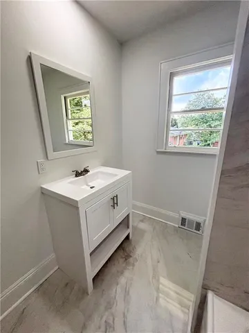 a bathroom with a sink and a window