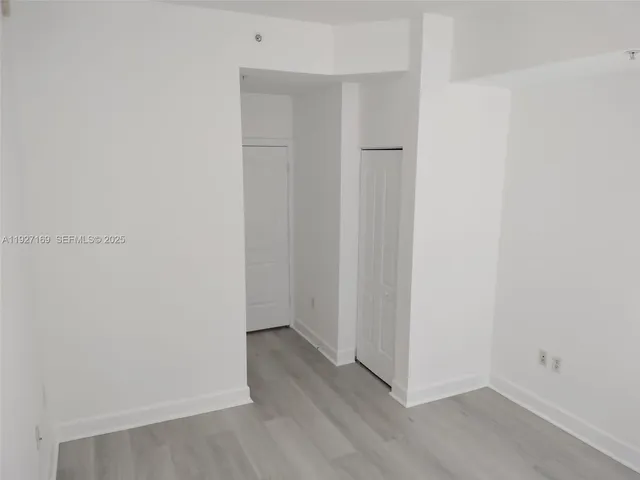 a bathroom with a granite countertop sink a mirror and a bathtub
