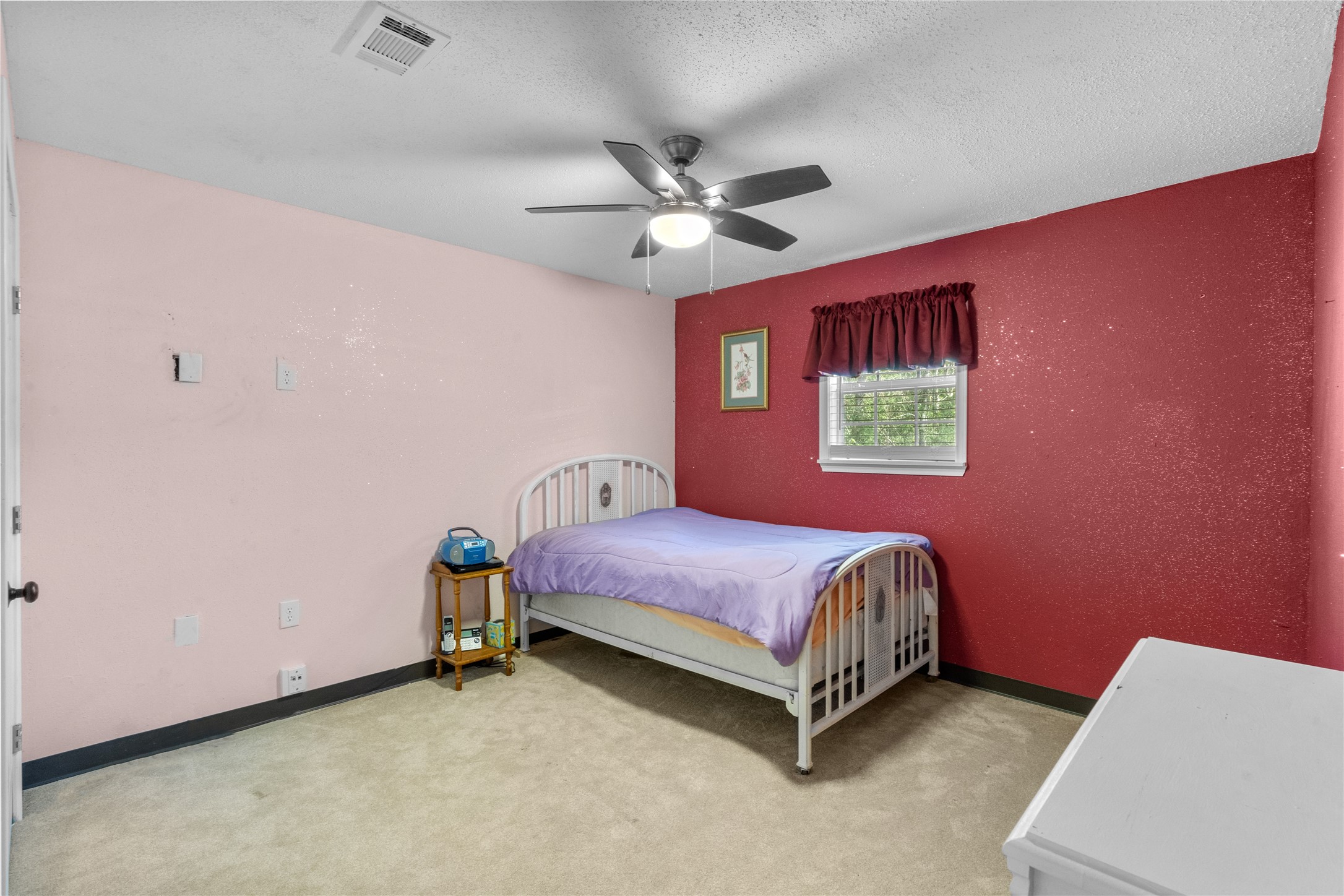 194 County Road 2775 Colmesneil, TX 75938 - Photo 14 of 22 a bedroom with a bed and a chandelier