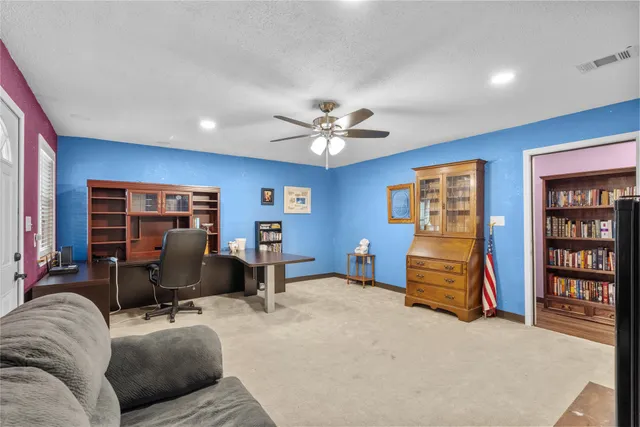 a living room with furniture gym equipment and a chandelier