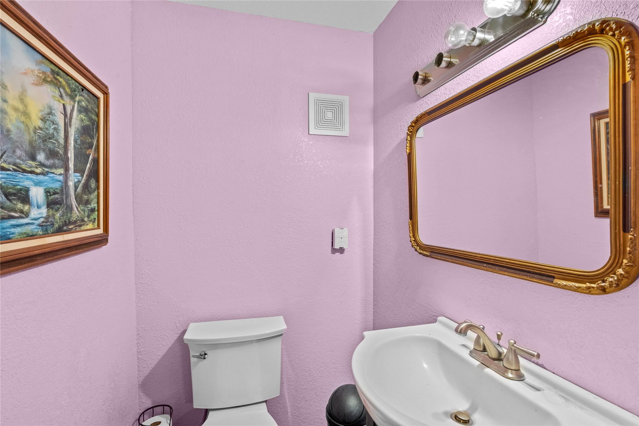 194 County Road 2775 Colmesneil, TX 75938 - Photo 19 of 22 a bathroom with a sink a mirror and a toilet