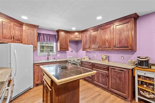 a kitchen that has a sink and a stove in it