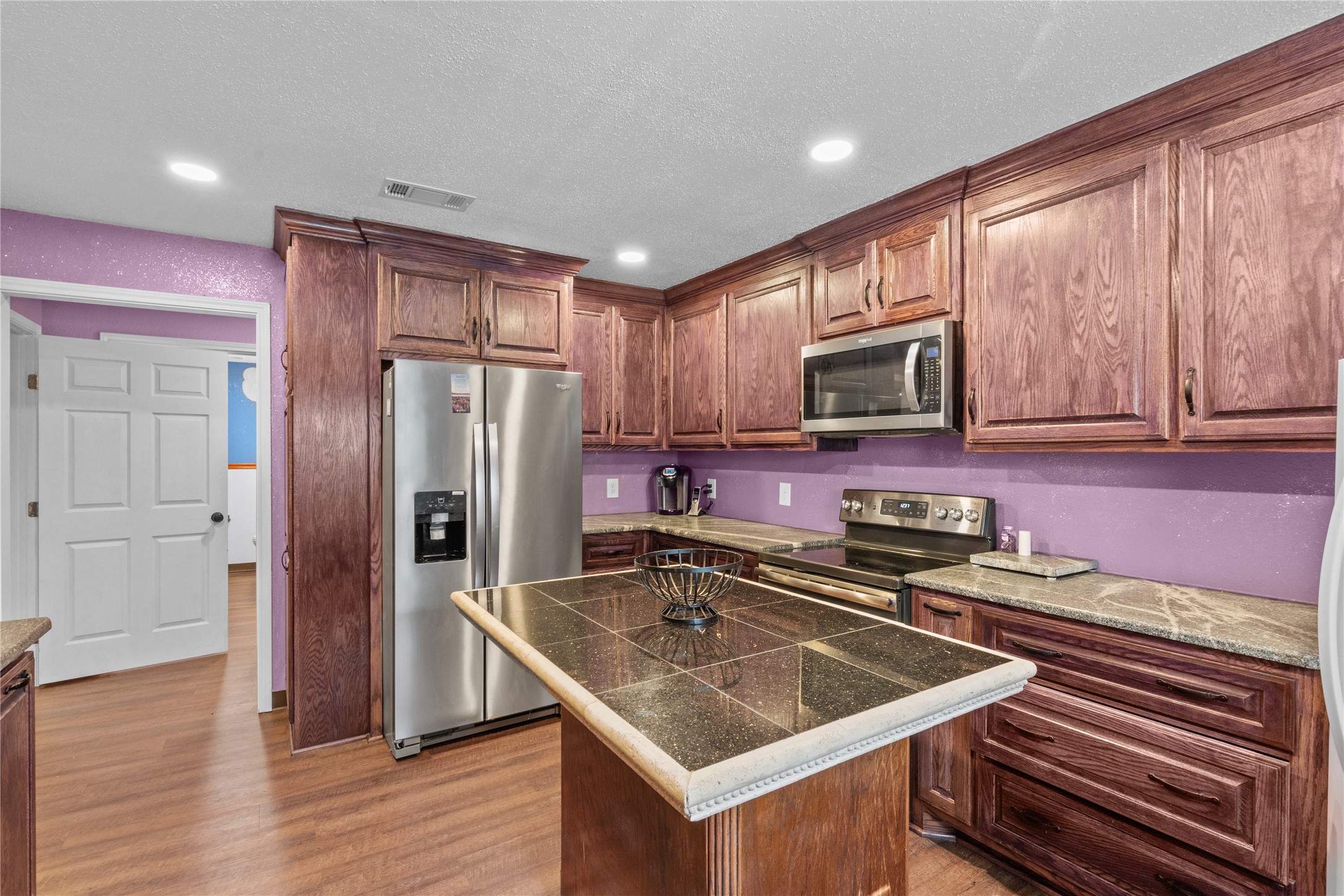 194 County Road 2775 Colmesneil, TX 75938 - Photo 10 of 22 a kitchen with stainless steel appliances granite countertop a sink stove microwave and refrigerator