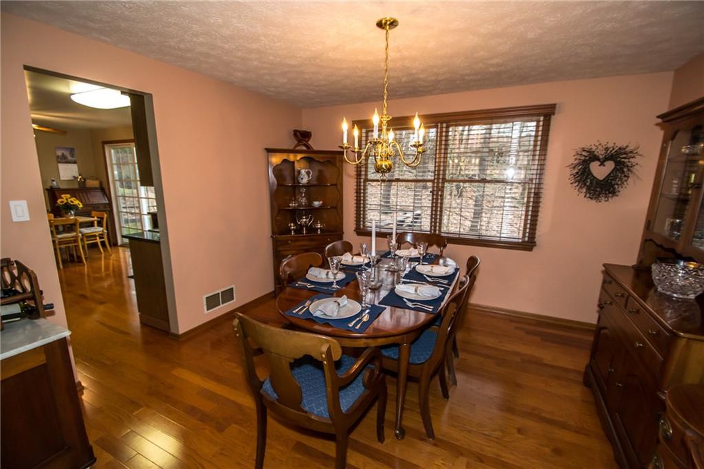 Hardwood flooring with a double colonial window overlooking the back yard.