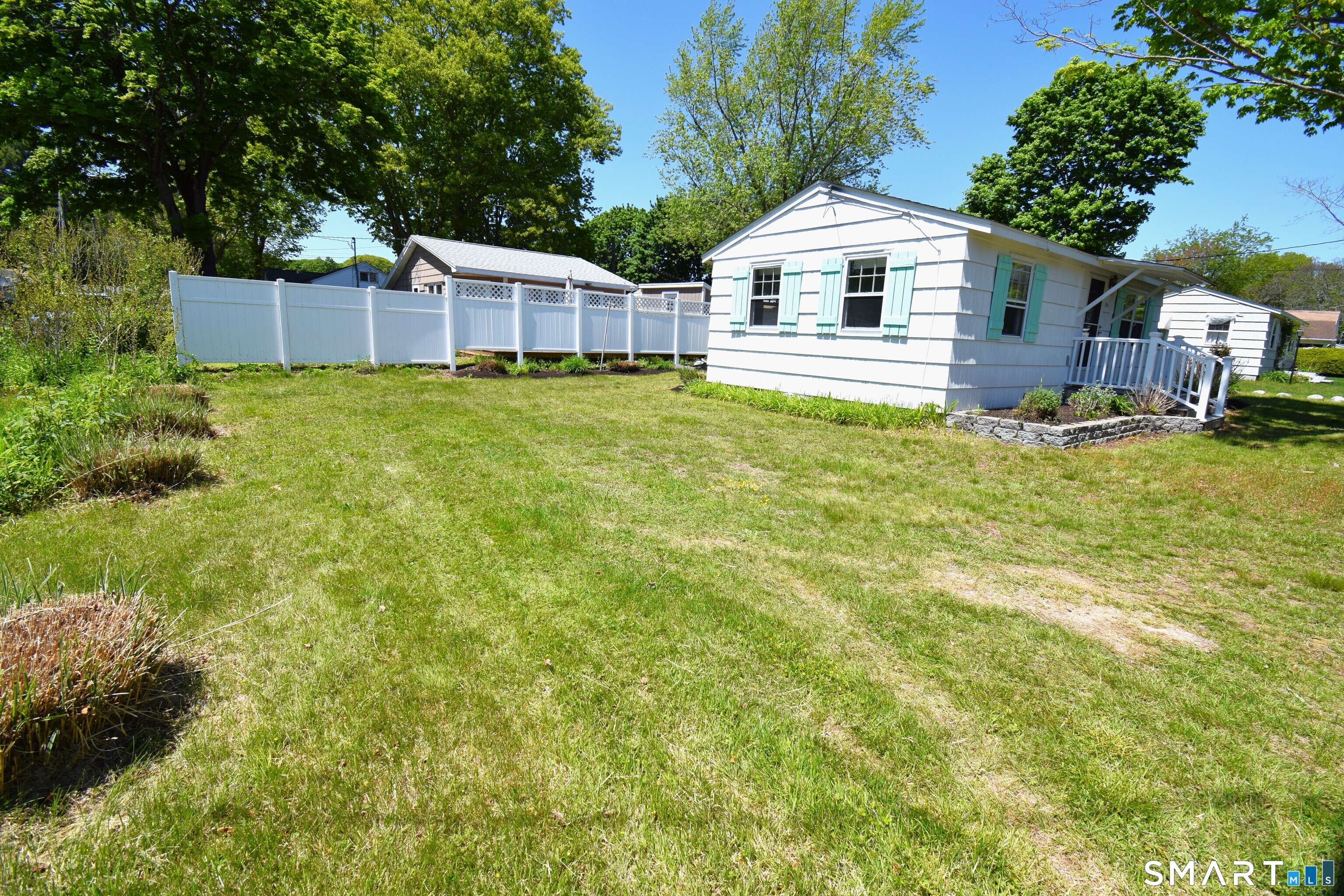 50 East Street Madison, CT 06443 - Photo 4 of 26 a front view of a house with a yard and trees