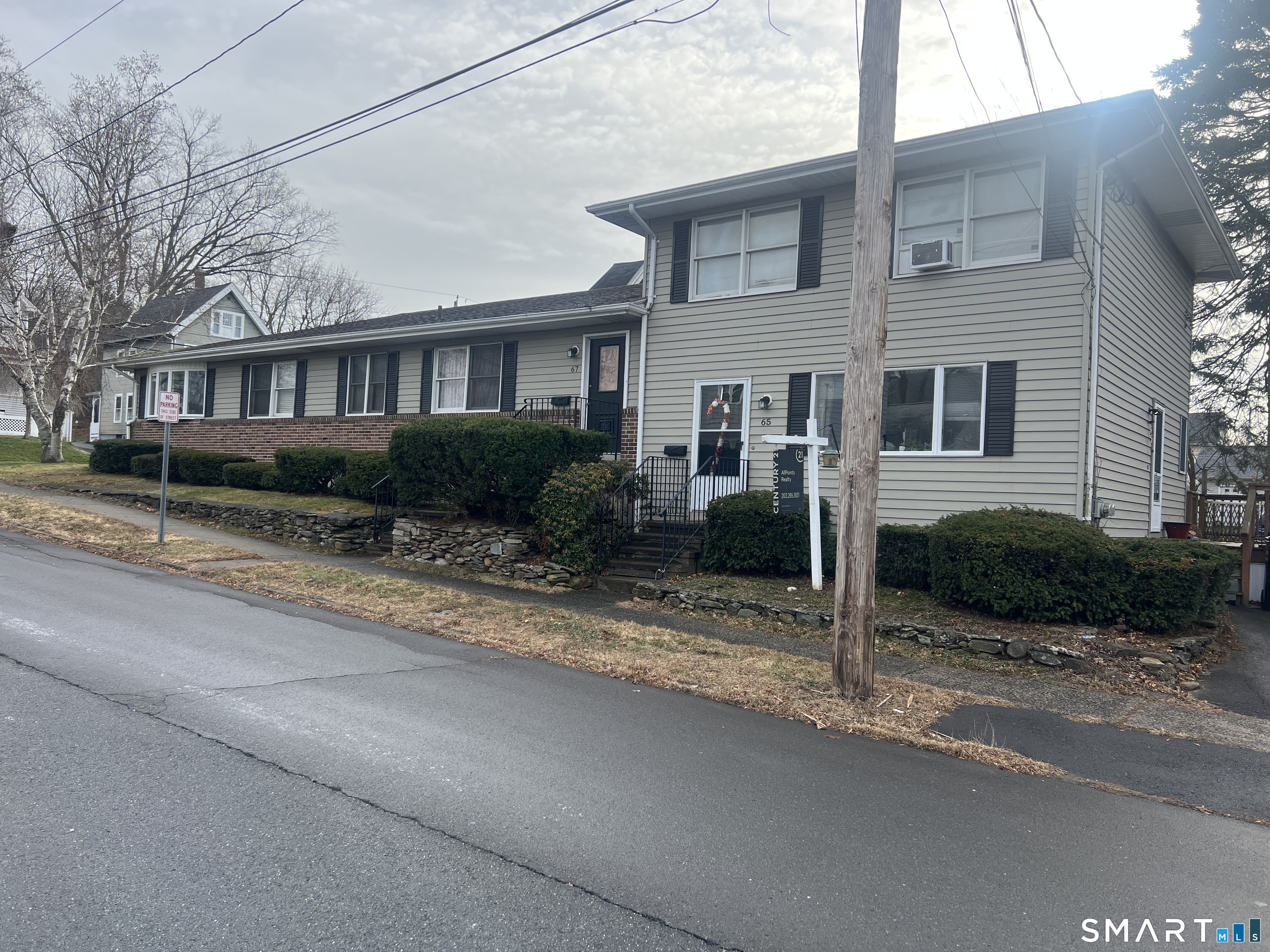 67 Spring Street Wallingford, CT 06492 - Photo 1 of 1 a view of a brick house next to a yard