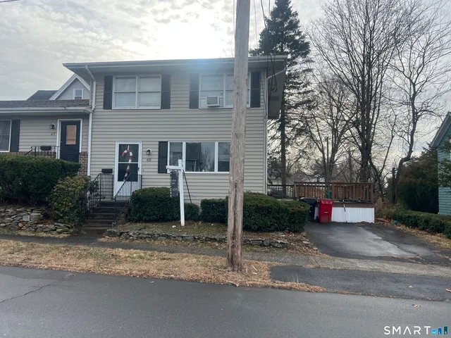 a view of a house with a yard and garage