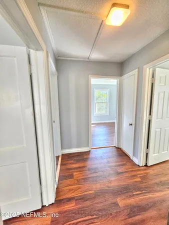 a view of entryway with window and wooden floor