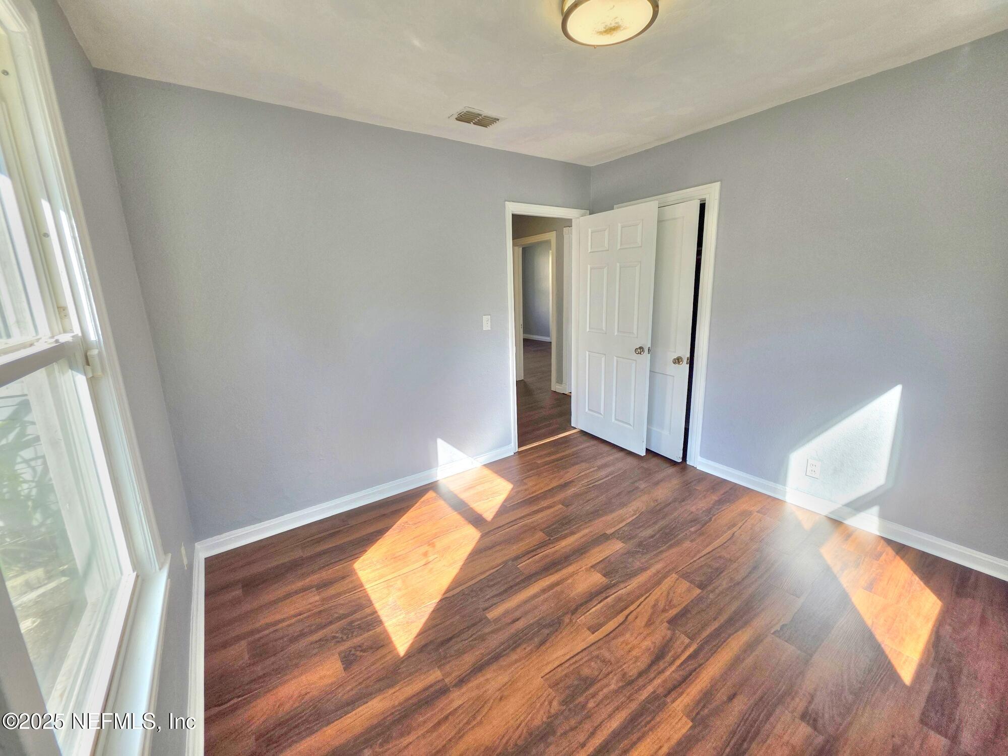 616 Woodbine Street Jacksonville, FL 32206 - Photo 17 of 25 a bedroom with a bed and a window