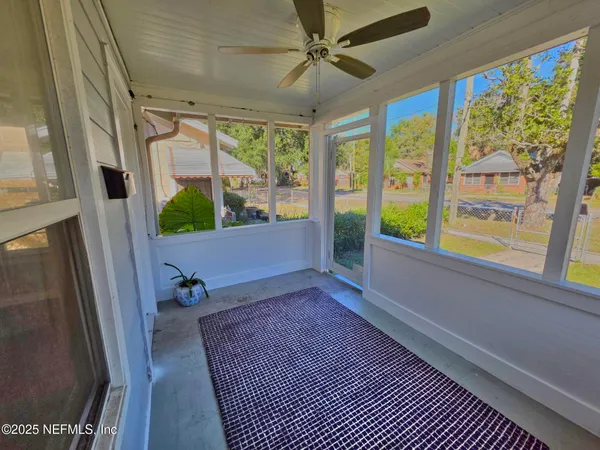 a view of room with window and a ceiling fan