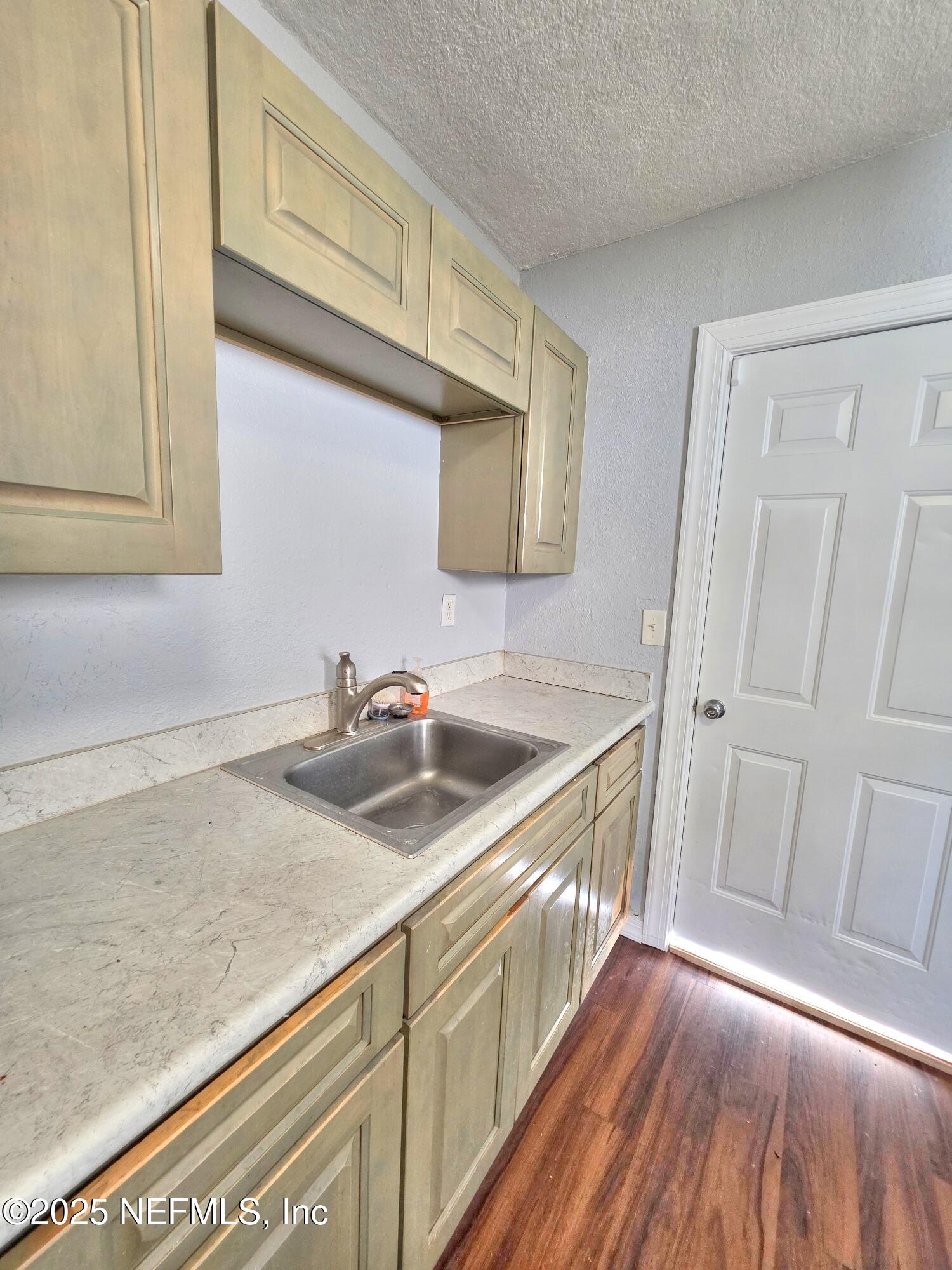 616 Woodbine Street Jacksonville, FL 32206 - Photo 10 of 25 a kitchen with a sink and a wooden floor
