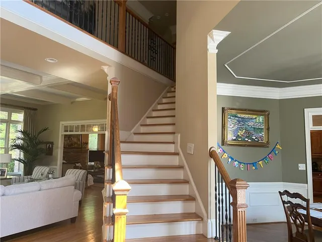 a view of entryway and hall with wooden floor