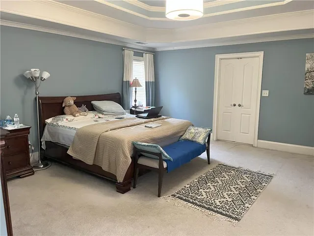 a bedroom with a bed dresser and a window