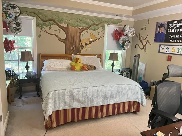 a bedroom with a bed and wall painting on the wall