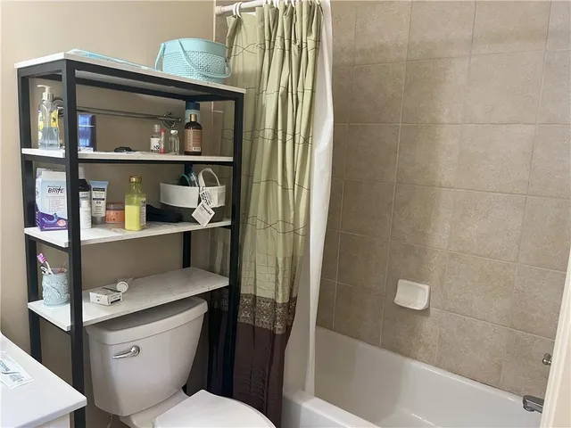 a bathroom with a toilet and a shower