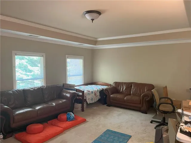 a living room with furniture a couch and a window