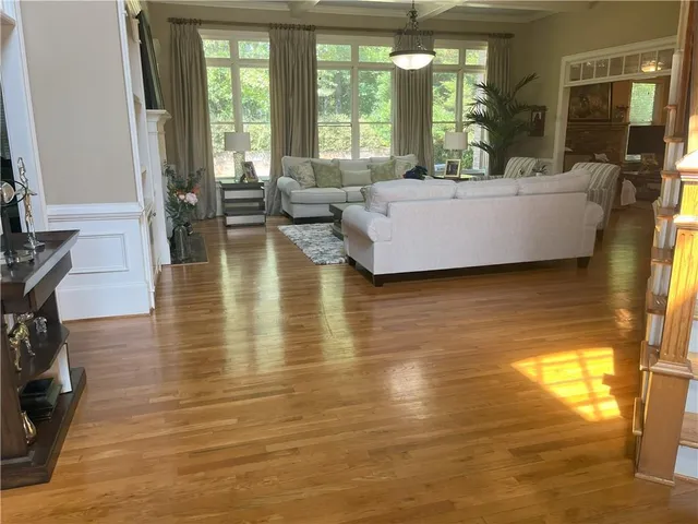 a living room with furniture and large windows