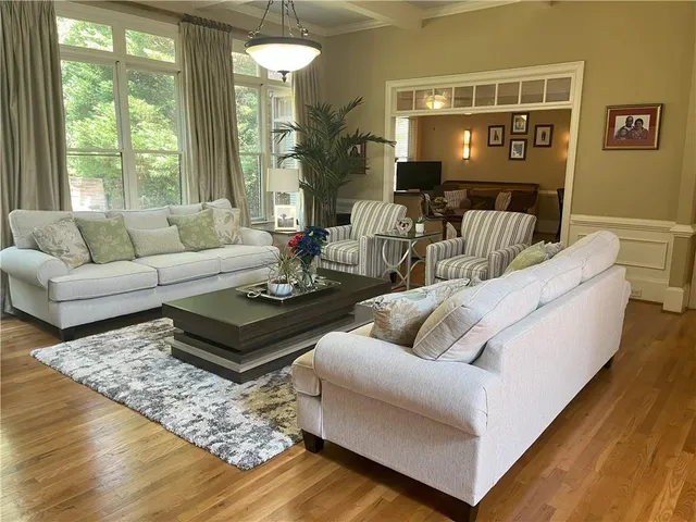 a living room with furniture and wooden floor