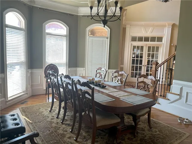 a view of a dining room with furniture and windows