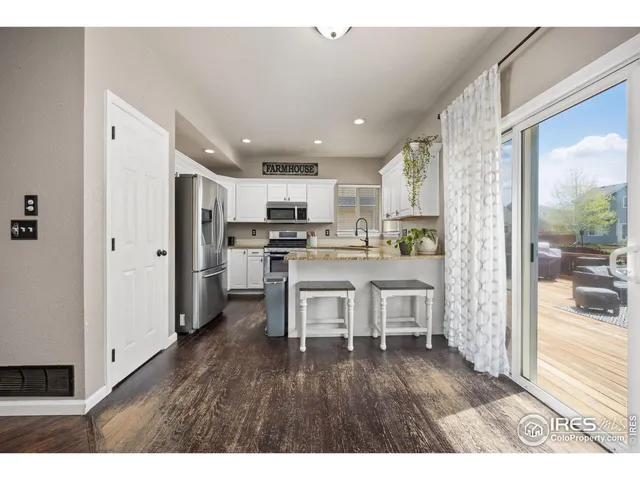 a open kitchen with white cabinets and stainless steel appliances