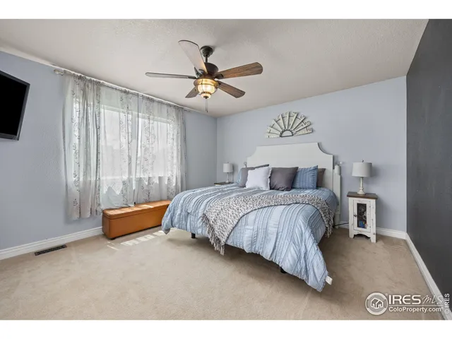 a bedroom with a bed and a tv