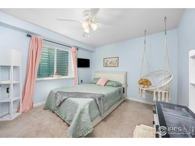 a bedroom with a bed a couch and chandelier