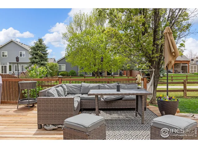 a front view of a house with a garden and trees