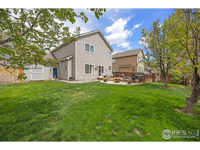 a view of a house with backyard and sitting area