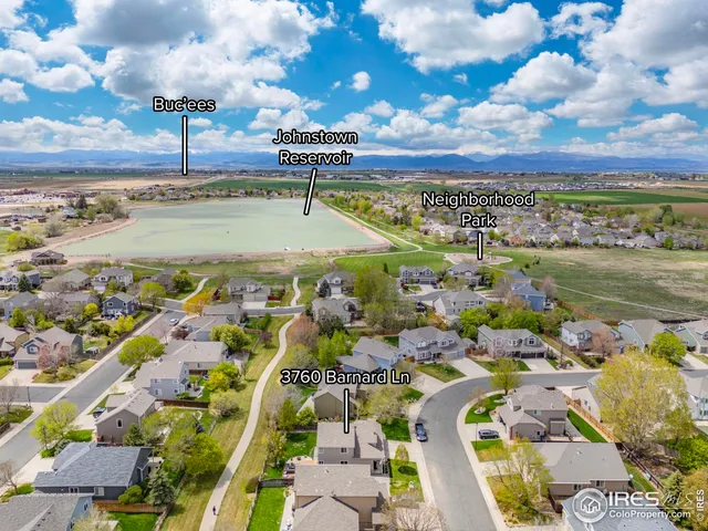 an aerial view of residential building and car parked