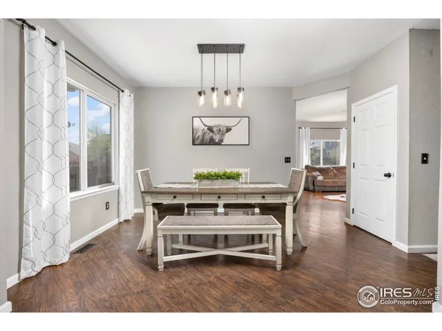 a living room with furniture a chandelier and a table
