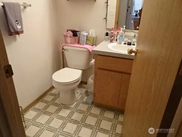 a bathroom with a sink toilet and a mirror