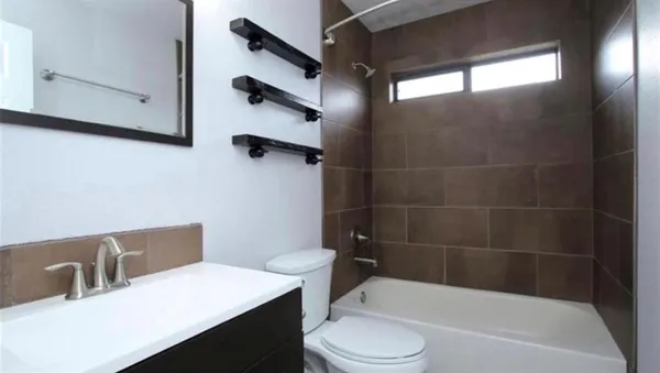 a bathroom with a sink a toilet and bathtub