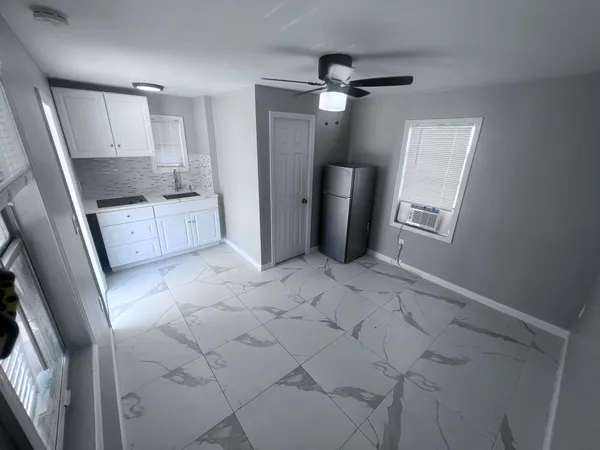 a kitchen with white cabinets