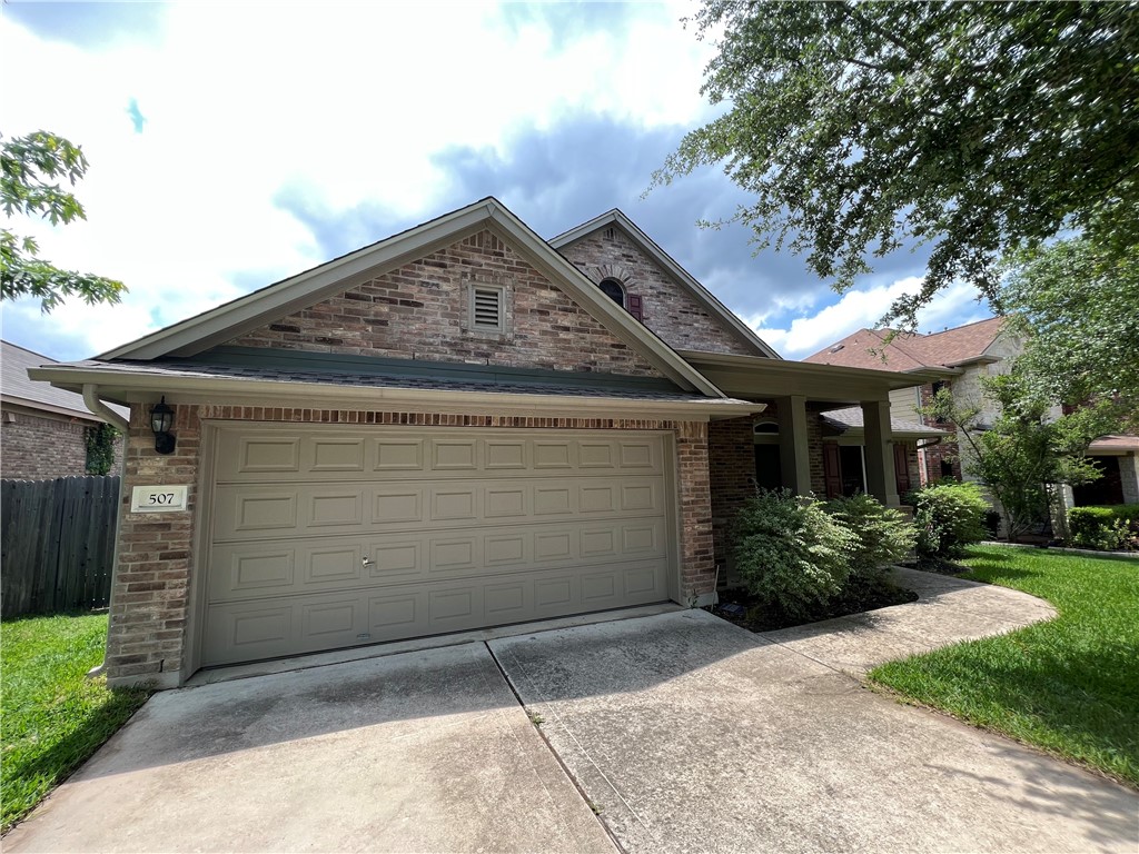 507 Red Hawk Drive Leander, TX 78641 - Photo 2 of 14 a front view of a house with a garden