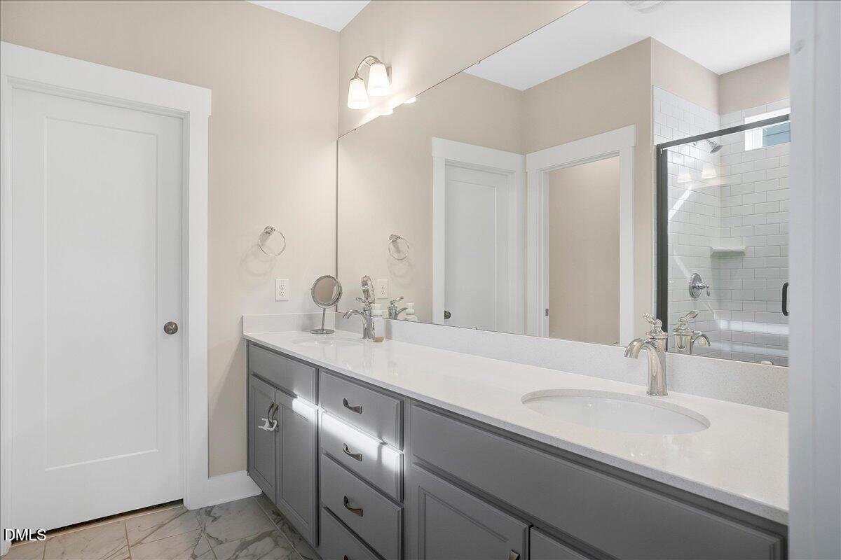 1105 Logperch Way Wendell, NC 27591 - Photo 15 of 29 a bathroom with a sink double vanity and a mirror