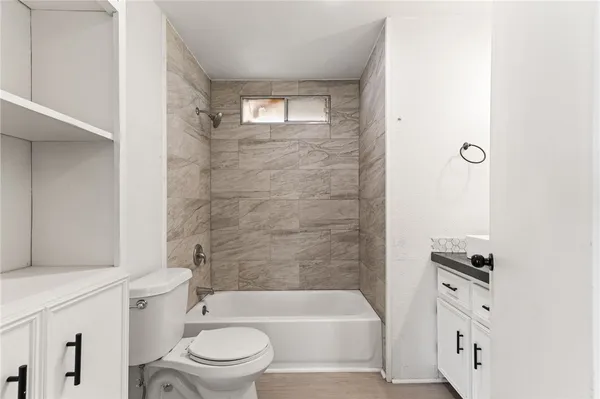 a bathroom with a bathtub toilet and sink