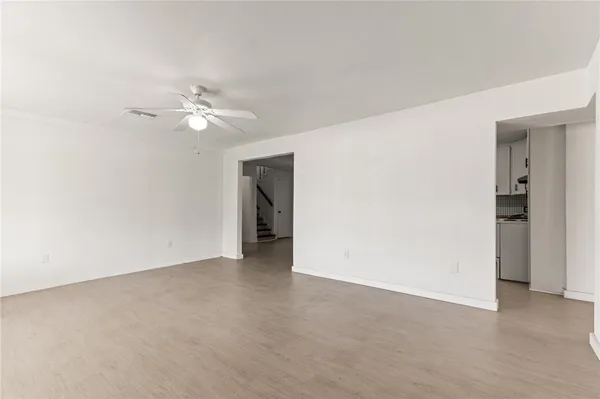 a view of an empty room with a ceiling fan