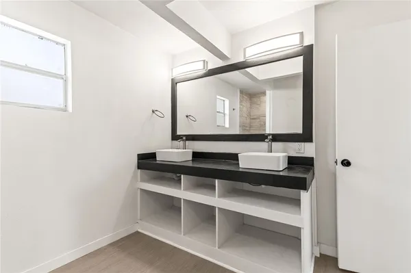 a bathroom with a sink and a mirror