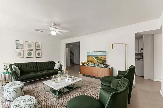 an empty room with closet and a chandelier fan