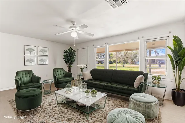 an empty room with closet and a ceiling fan