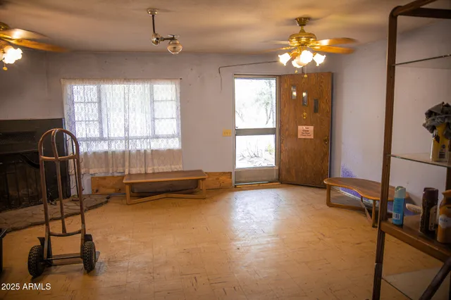 a kitchen with stainless steel appliances granite countertop a stove a refrigerator a sink a dining table and chairs with wooden floor