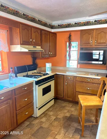 a view of a livingroom with furniture window and wooden floor