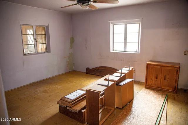 a view of a room with a window and a ceiling fan