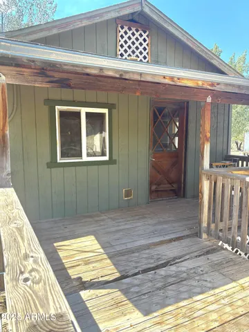 a view of a house with a yard covered in snow